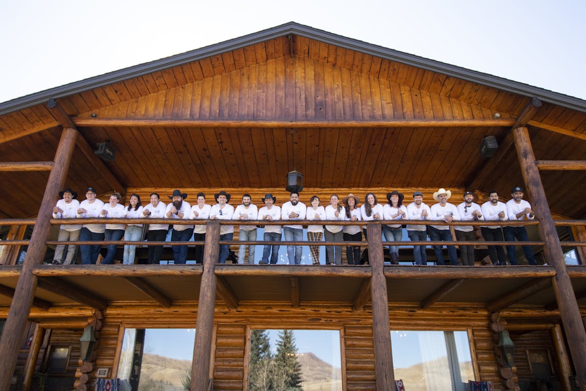 The Echobind team lined up on the balcony of the cabin
