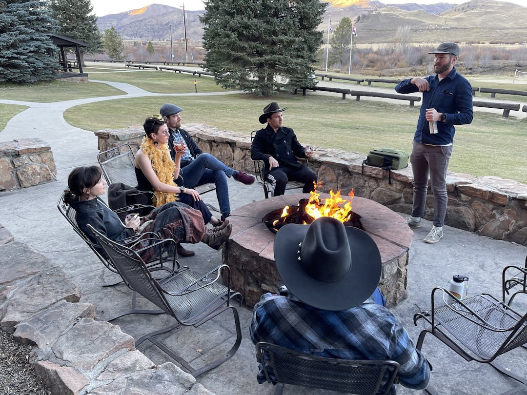Echobind team members chatting around a campfire