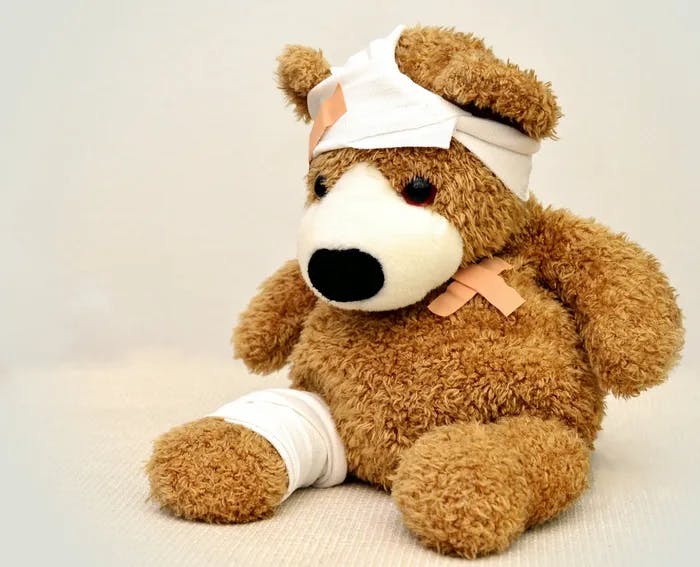 Brown teddy bear with bandages