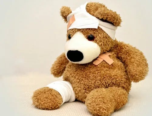 Brown teddy bear with bandages