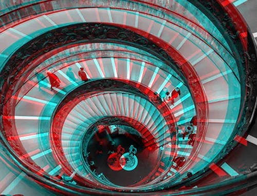 A spiral staircase with a red and blue 3d effect.