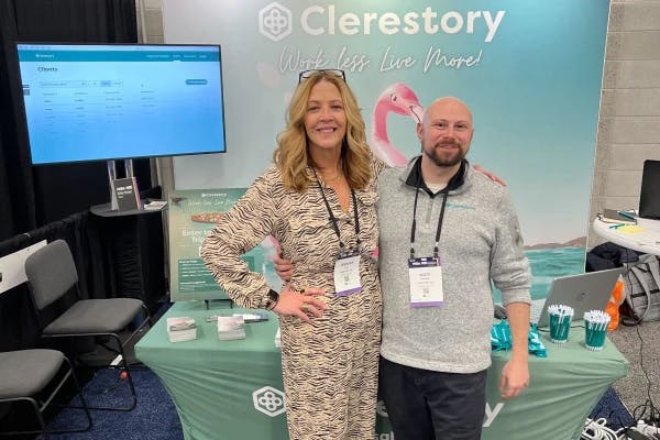 A photo of Clerestory members in front of their tradeshow booth.