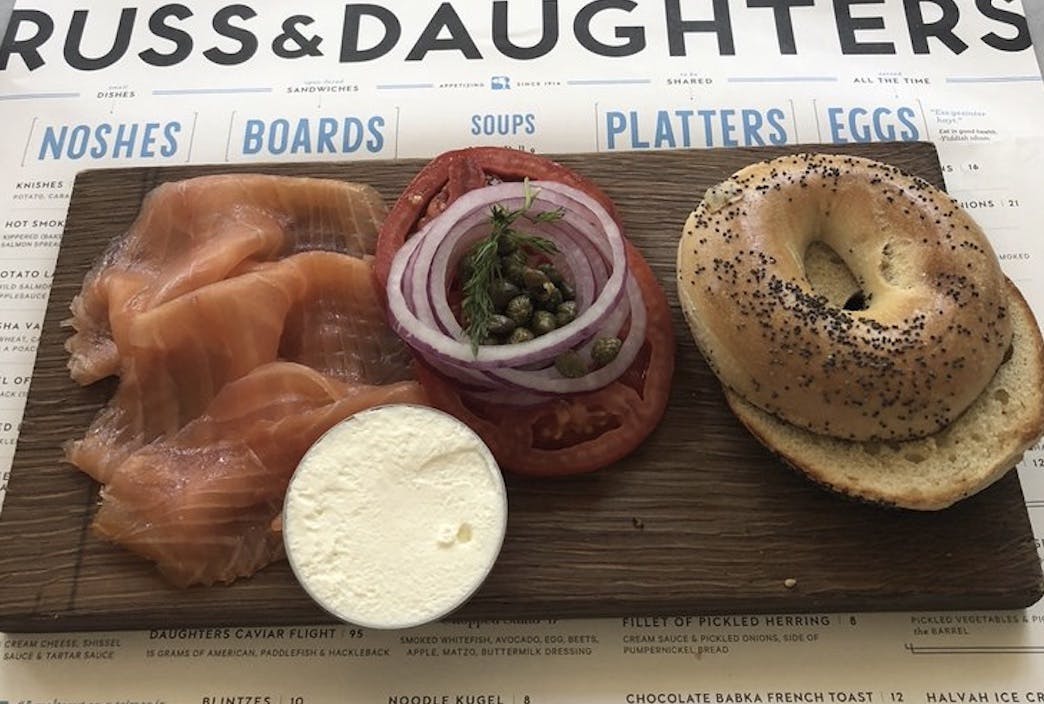 Board with a bagel, lox, and cream cheese