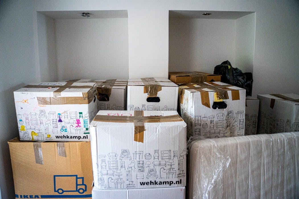 Moving boxes stack on top of each other in a room