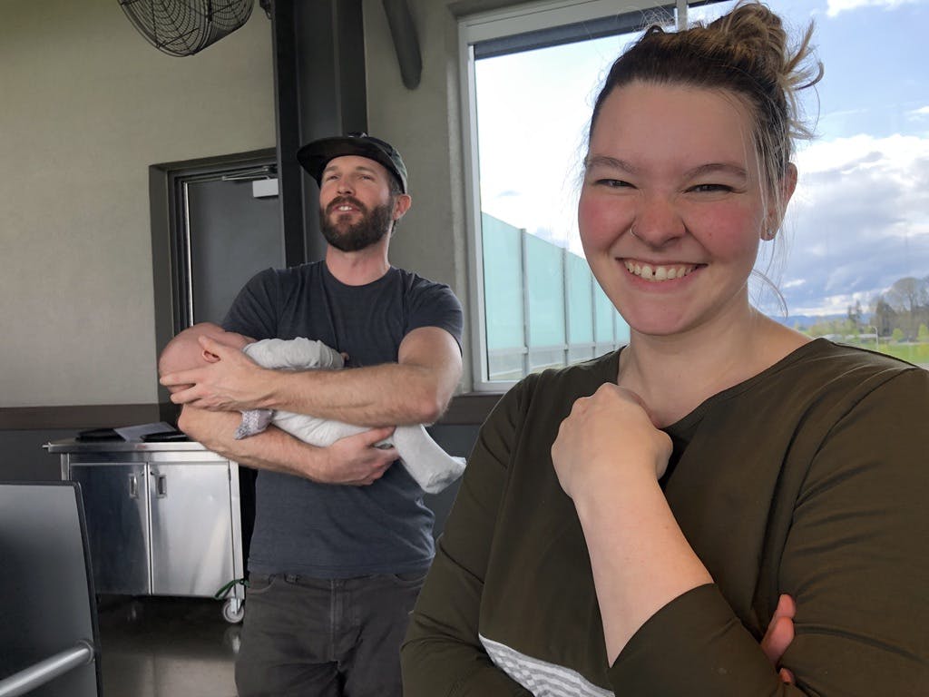 Woman smiling and man holding baby