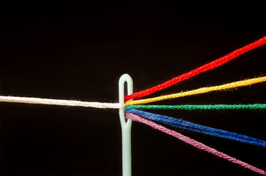 multi-colored yarn through a needle