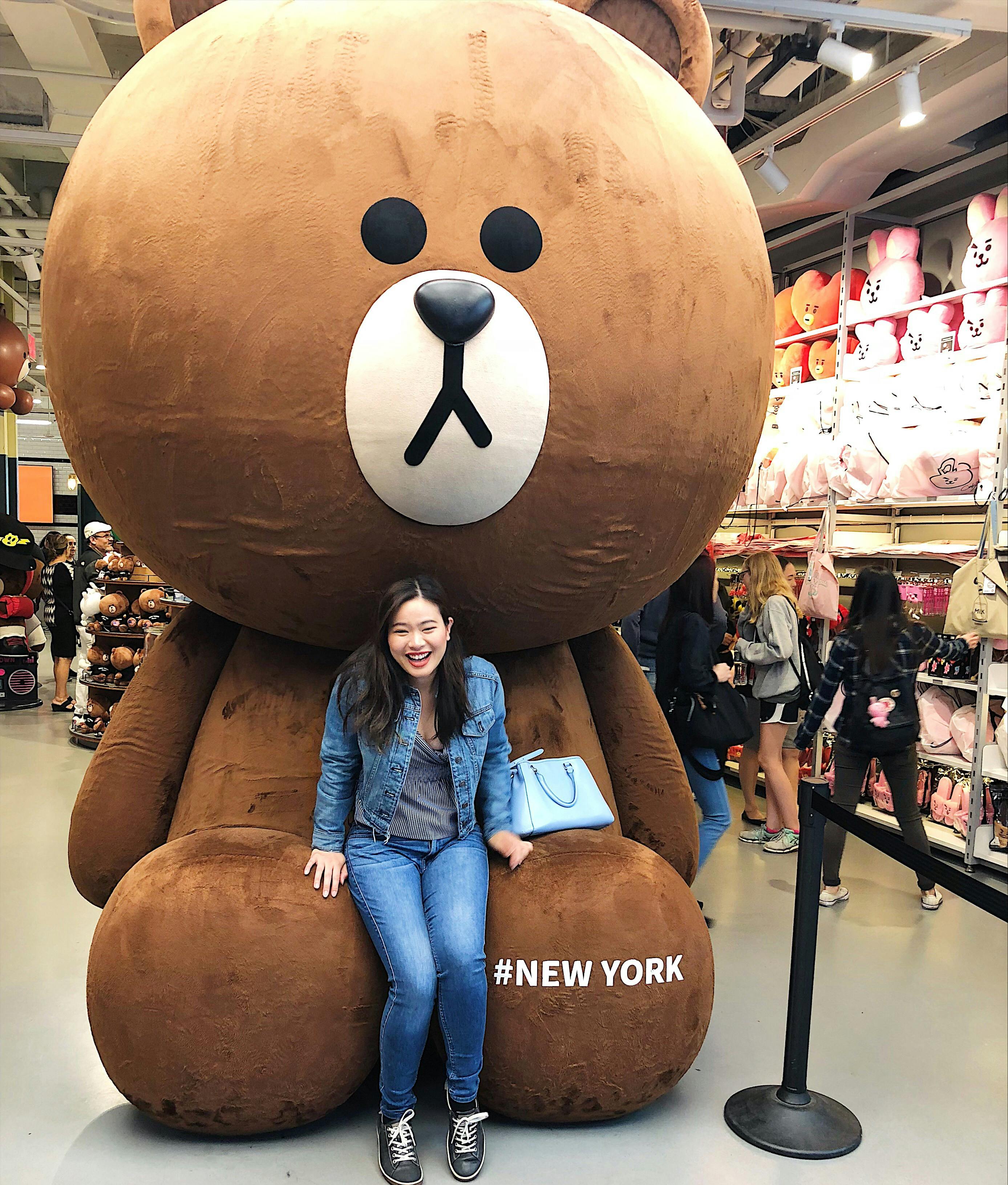 Chelsea Galvez sitting on oversized teddy bear