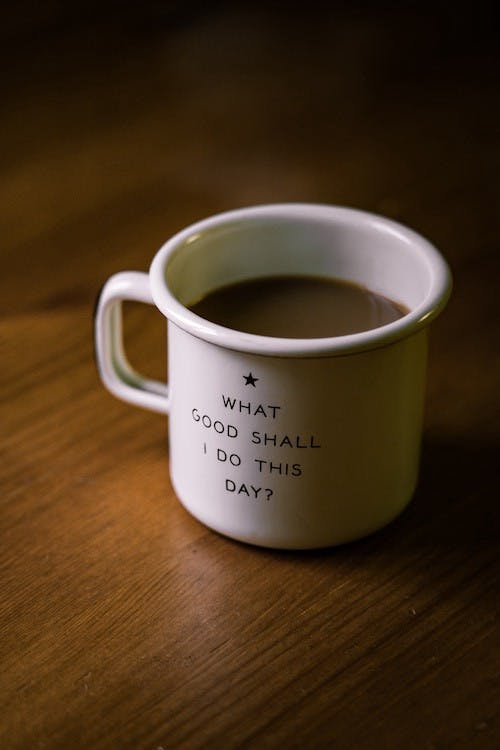 Coffee cup with What Good Shall I do this day? written on it